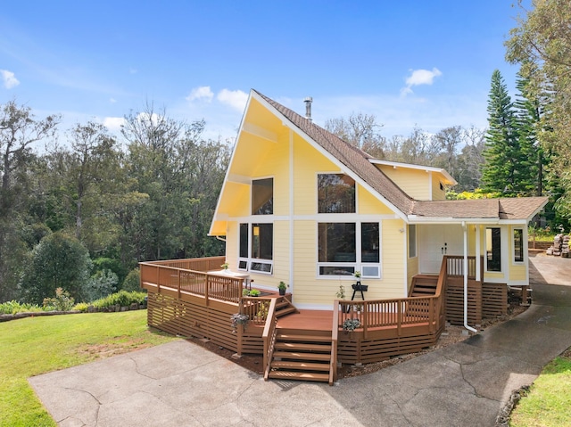 1733 Piiholo Rd, Makawao, HI 96768 - view of front facade with a shingled roof, a front lawn, a wooden deck, and a patio area
