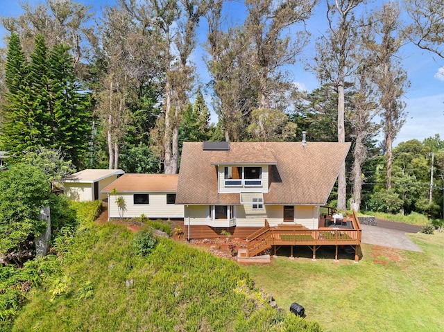 1733 Piiholo Rd, Makawao, HI 96768 - rear view of property featuring a yard, roof mounted solar panels, a wooden deck, and a shingled roof