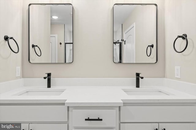 bathroom with a sink and double vanity