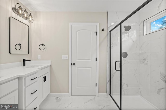 full bathroom featuring marble finish floor, a marble finish shower, baseboards, and vanity