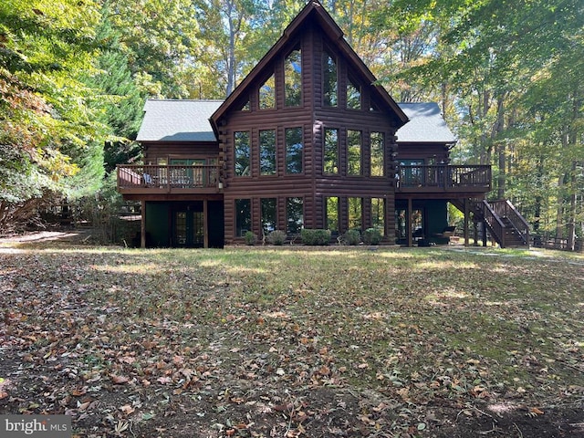 rear view of property featuring log exterior, a deck, and stairs