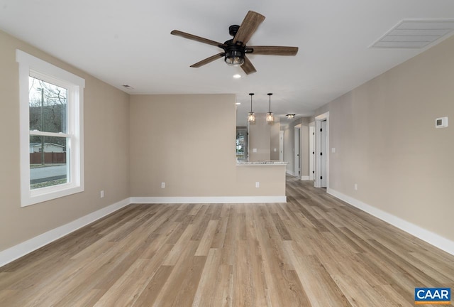 unfurnished living room featuring light hardwood / wood-style floors and ceiling fan