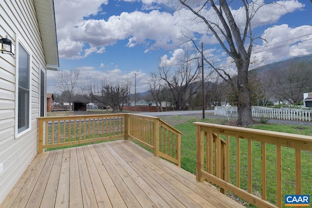 wooden deck with a lawn