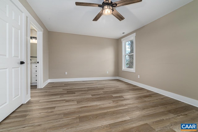 unfurnished bedroom with ceiling fan and light hardwood / wood-style flooring