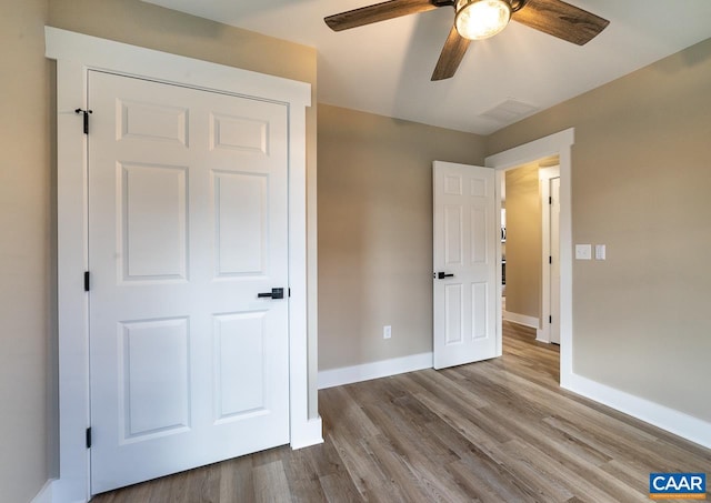 unfurnished bedroom with light hardwood / wood-style flooring and ceiling fan