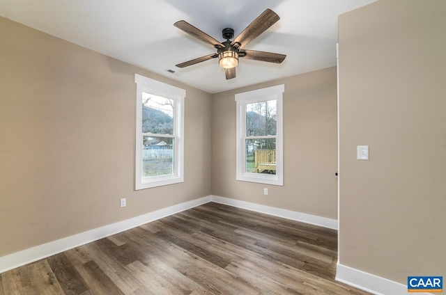 unfurnished room with hardwood / wood-style floors and ceiling fan