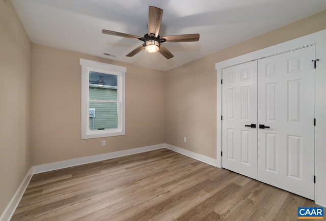 unfurnished bedroom with a closet, ceiling fan, and light wood-type flooring