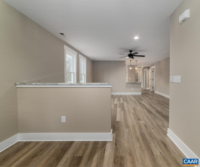 unfurnished living room with ceiling fan and light hardwood / wood-style floors