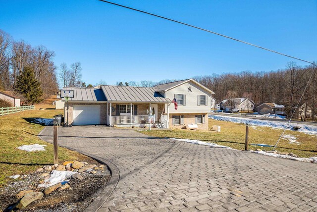 view of front of house with a garage, a front lawn, and a porch