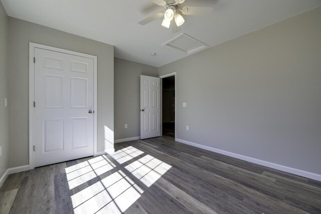 unfurnished bedroom featuring ceiling fan and dark hardwood / wood-style floors