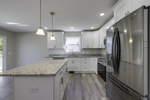 kitchen with stainless steel appliances, white cabinetry, and sink