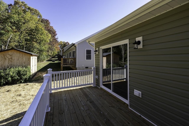 wooden terrace with a shed