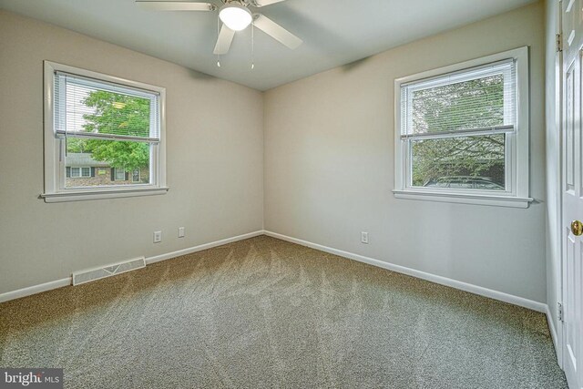 empty room featuring carpet and ceiling fan