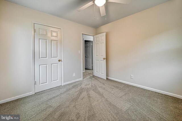 unfurnished bedroom with ceiling fan and carpet flooring