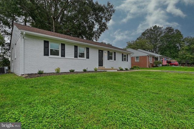 ranch-style house featuring central AC unit and a front lawn