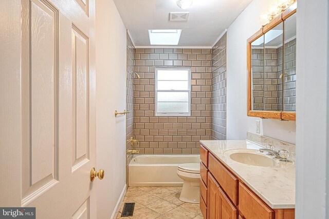 full bathroom with tile patterned flooring, vanity, toilet, and tiled shower / bath