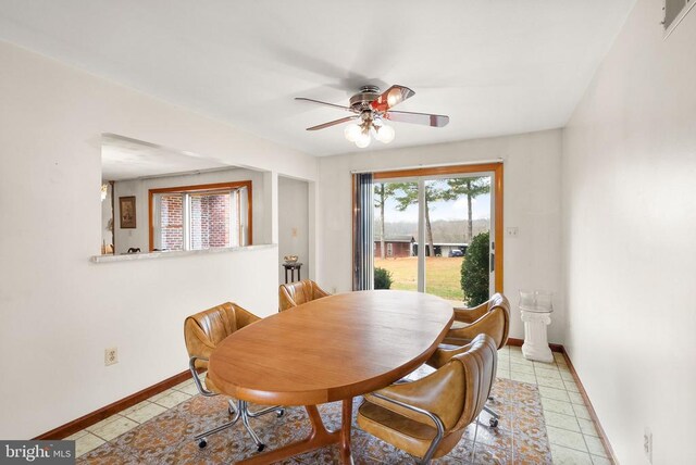 dining area with light tile patterned floors, baseboards, and a ceiling fan