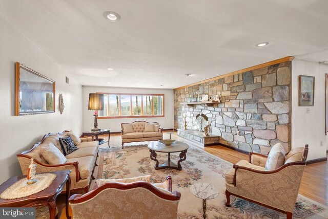 living area with visible vents, wood finished floors, and recessed lighting