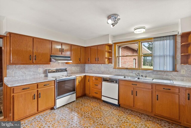 kitchen with white appliances, light countertops, under cabinet range hood, open shelves, and backsplash