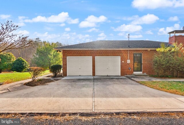 view of front of house featuring driveway, brick siding, an attached garage, and a shingled roof