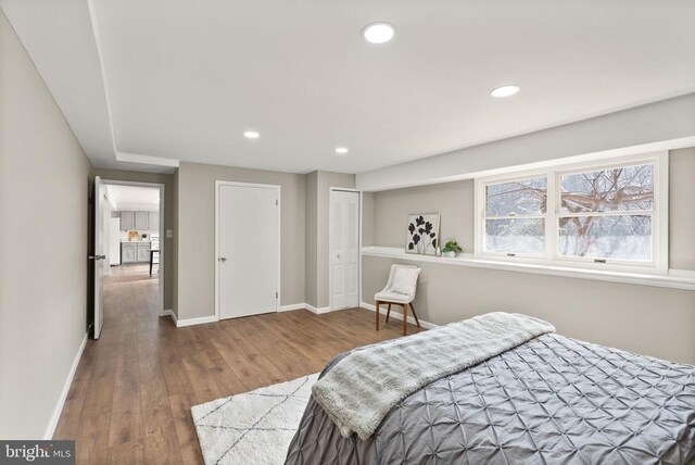 bedroom featuring recessed lighting, wood finished floors, and baseboards