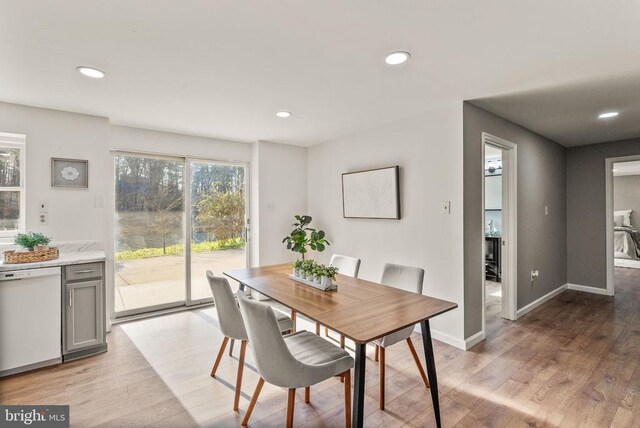 dining room featuring baseboards, light wood-style flooring, and recessed lighting