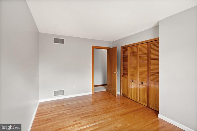 unfurnished bedroom featuring light wood-type flooring, visible vents, and baseboards