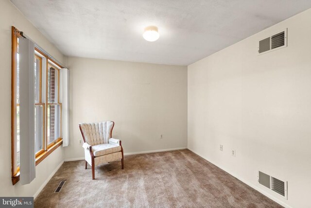 unfurnished room featuring carpet and visible vents