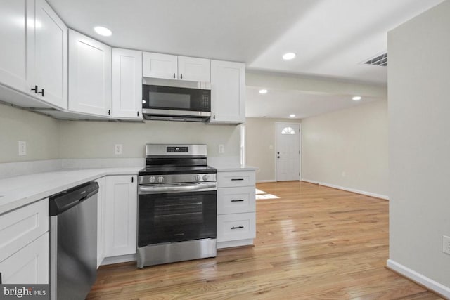 kitchen featuring white cabinetry, appliances with stainless steel finishes, and light hardwood / wood-style flooring