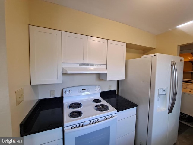 kitchen featuring dark countertops, under cabinet range hood, white cabinetry, and white appliances