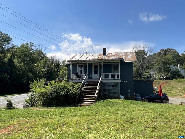 view of front of property with a porch and a front yard