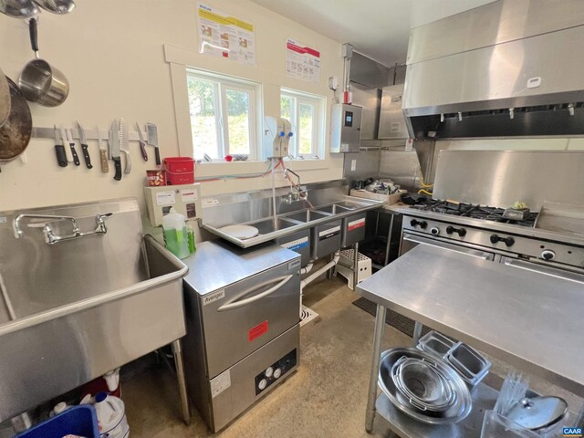 kitchen featuring island range hood, sink, and stainless steel counters