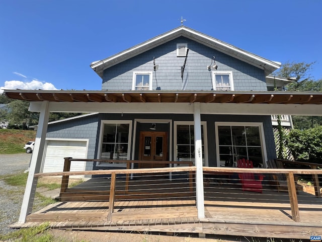 back of property featuring a garage and a porch