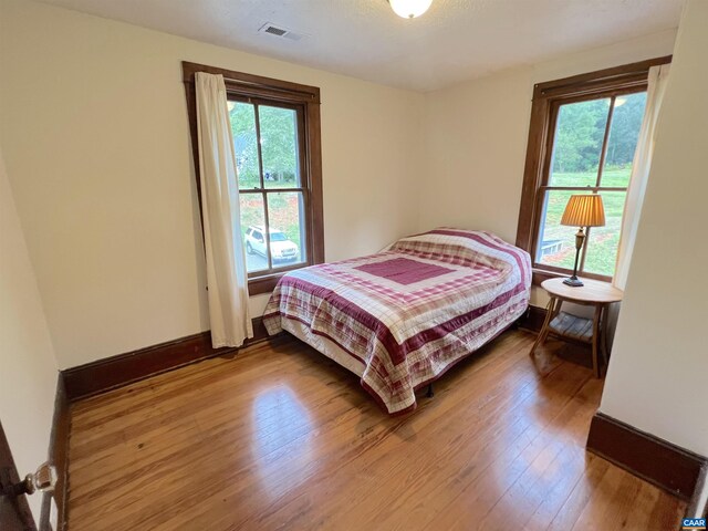 bedroom with hardwood / wood-style floors