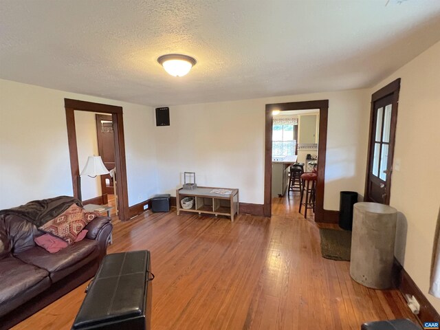 living room with hardwood / wood-style floors and a textured ceiling