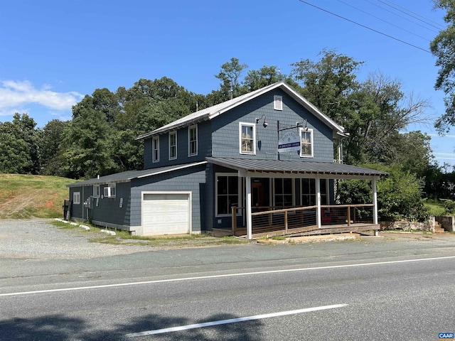 farmhouse-style home with a garage and covered porch