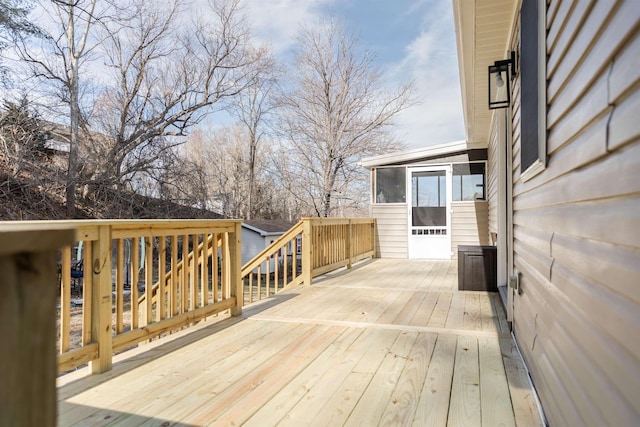 wooden deck featuring a sunroom