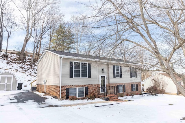 split foyer home featuring a shed