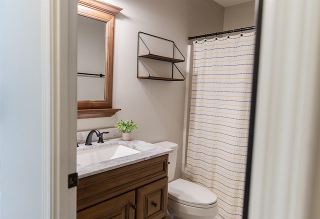 bathroom with vanity, toilet, and walk in shower