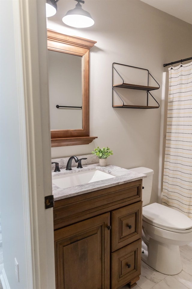 bathroom featuring a shower with curtain, marble finish floor, vanity, and toilet