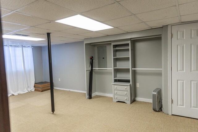 basement featuring carpet floors and a drop ceiling