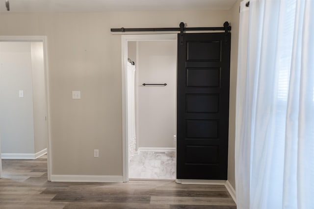 interior space featuring wood-type flooring and a barn door