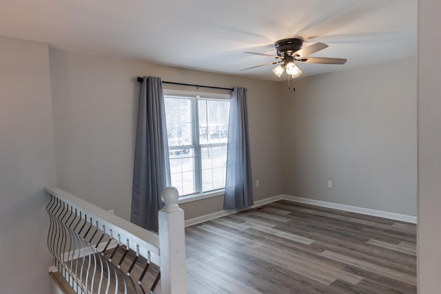 unfurnished room featuring dark hardwood / wood-style flooring and ceiling fan