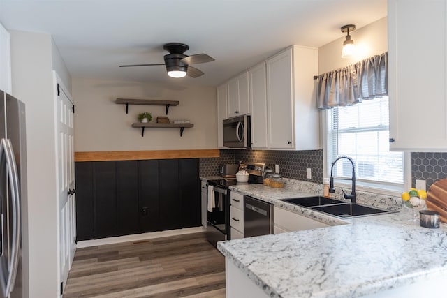 kitchen with open shelves, appliances with stainless steel finishes, a sink, and white cabinets