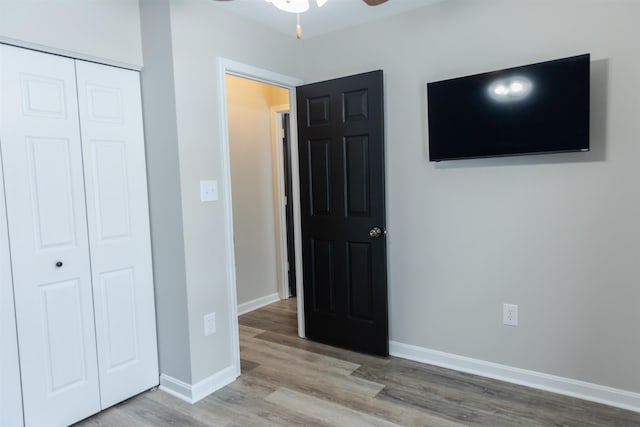 unfurnished bedroom with hardwood / wood-style floors and a closet