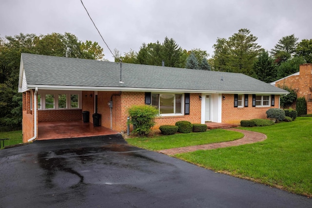 single story home featuring a carport and a front lawn