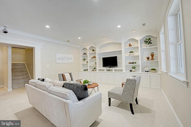 living room with ornamental molding, light carpet, and built in features