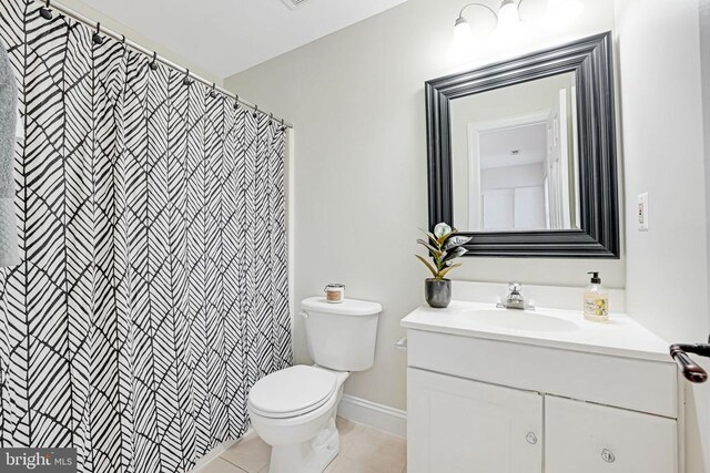 bathroom with vanity, tile patterned floors, and toilet