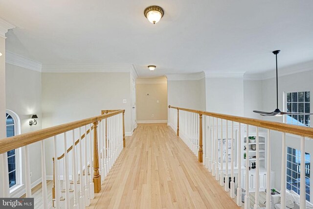 hall with hardwood / wood-style flooring and crown molding