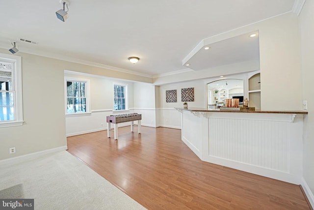 playroom with crown molding and wood-type flooring